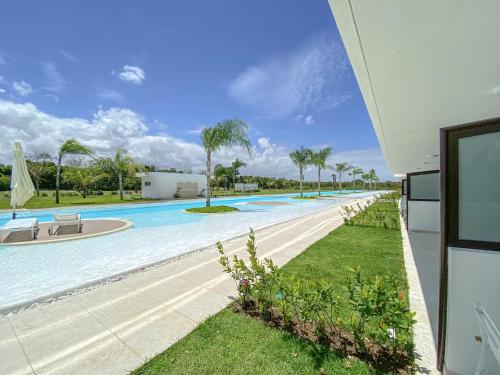 a large swimming pool next to a building at Xeliter Cana Rock Punta Cana in Punta Cana