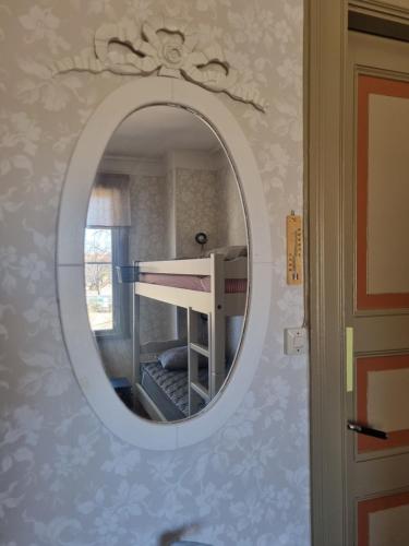 a mirror in a room with a bunk bed at Villa Eira vandrarhem in Hjo