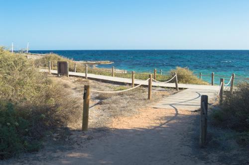 a path to the beach with the ocean in the background at Es Pi 2 in Playa Migjorn