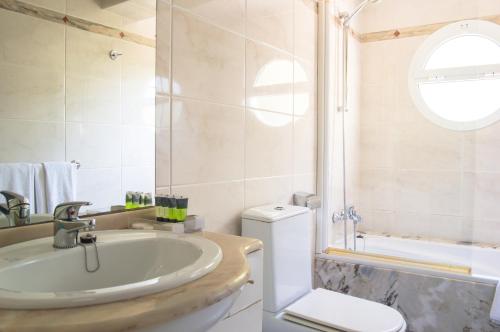 a bathroom with a tub and a toilet and a sink at Es Pi 2 in Playa Migjorn