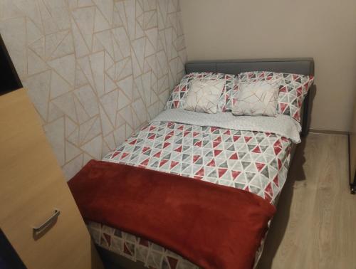 a small bed in a small room with a bed frame at Mieszkanie na wakacje nad morzem in Gdańsk
