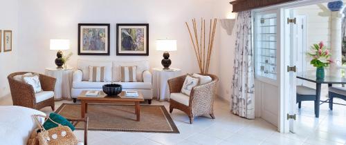 a living room with a couch and chairs and a table at Coral Reef Club in Saint James
