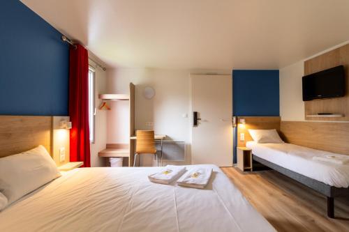 Ένα ή περισσότερα κρεβάτια σε δωμάτιο στο BRIT Hotel Rouen Nord - Barentin