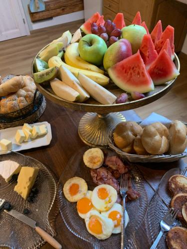 a table topped with two trays of breakfast foods at Penzion U Kapra in Roudnice nad Labem