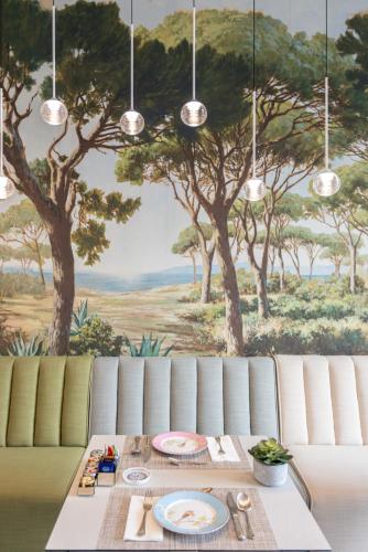 a dining room with a table and a painting of trees at Palazzo Marziale in Sorrento