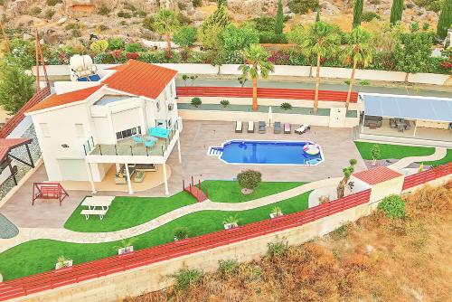an aerial view of a house with a swimming pool at Villa Prasino in Coral Bay