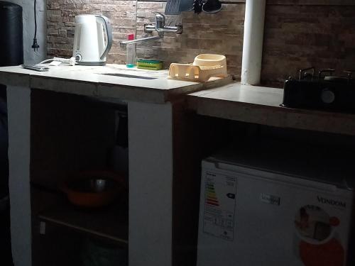 a kitchen counter with a sink and a microwave at Rinconada 3 in Las Grutas