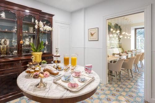 a dining room with a table with food on it at Palazzo Marziale in Sorrento