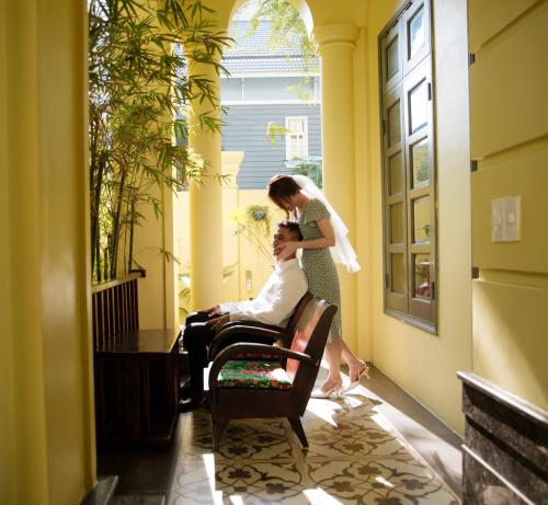 a bride and groom standing in a hallway at Thi Boutique Villa in Danang