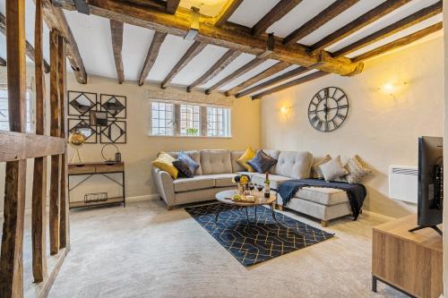 a living room with a couch and a table at Characteristic 4 Bed Apartment in the Heart of Windsor in Windsor