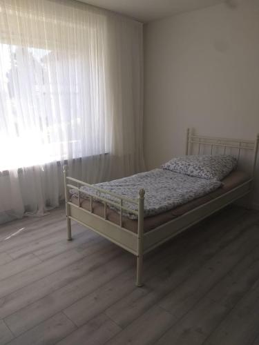 a bedroom with a bed in a room with a window at Pension Rückert in Kassel