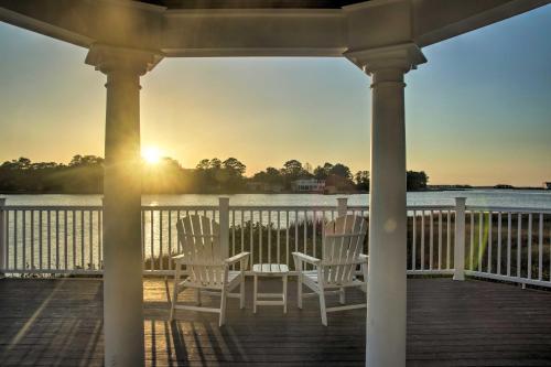 a porch with chairs and the sunset on the water at Deck, Balcony Scenic Ocean View Beach Getaway! in Ocean View