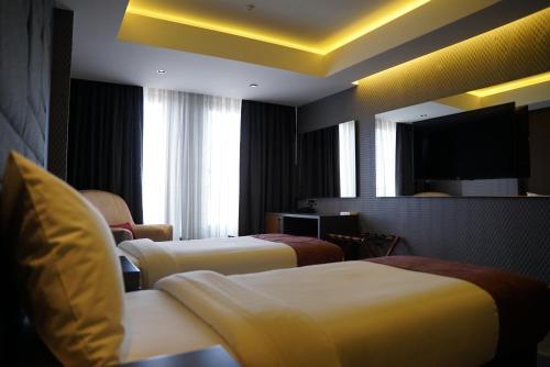 Ένα ή περισσότερα κρεβάτια σε δωμάτιο στο Nova Vista Deluxe & Suites a Member of Radisson Individuals