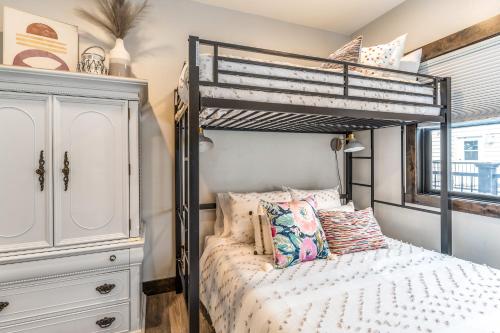 a bedroom with a bunk bed and a dresser at The Electric Bungalow in Bigfork