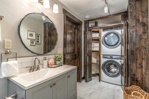 a bathroom with a sink and a washing machine at The Electric Bungalow in Bigfork
