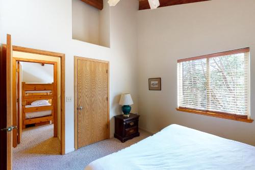 a bedroom with a bed and a window and a door at Streiff Lake House in Bass Lake