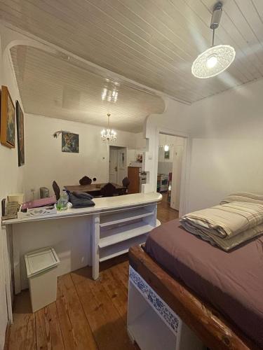 a bedroom with a bed and a desk in it at Harmony Gallery in Ljubljana