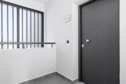 a black door in a room with a staircase at Sky Island House - Design Maisonette Kallithea in Kallithea Halkidikis