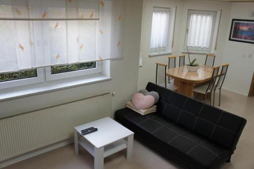 a living room with a couch and a table at Ferienwohnung Martin in Neuhausen ob Eck
