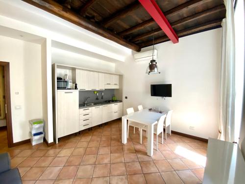 a kitchen and dining room with a table and chairs at SWEETSUITE Rome in Rome