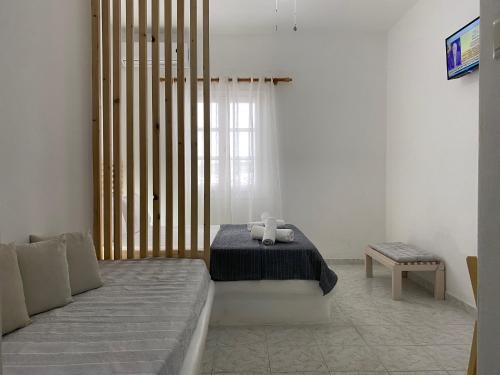 a bedroom with a bed with a teddy bear on it at Serene Hill in Naousa