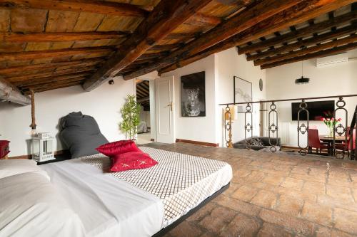 a bedroom with a large white bed with a red pillow at Rooftop Campo dei Fiori in Rome