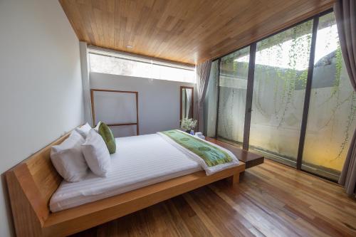 Un pat sau paturi într-o cameră la The Purple Hue Homestay