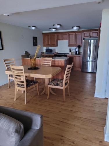 a kitchen and dining room with a table and chairs at Muskoka Lakes Hotel and Resorts in Port Carling