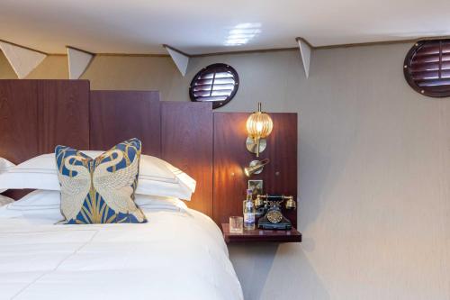 a bedroom with a large bed and two windows at Ocean Mist Leith in Edinburgh