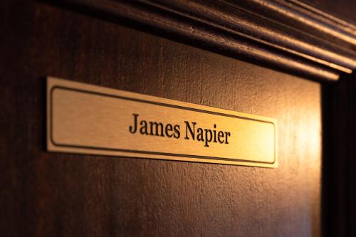 a sign on a door that reads james napper at Ocean Mist Leith in Edinburgh