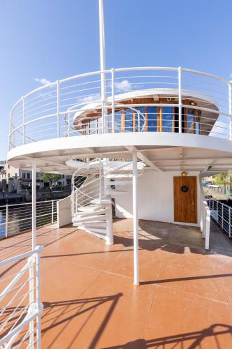 a balcony on a cruise ship with a wooden door at Ocean Mist Leith in Edinburgh
