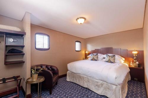 a hotel room with a bed and a chair at Ocean Mist Leith in Edinburgh