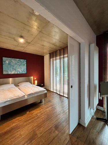 a bedroom with a bed and wooden floors at Gossler Suite in Hamburg