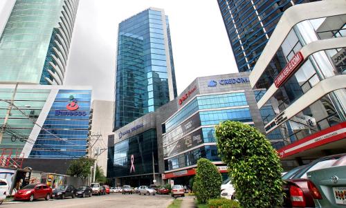 a busy city street with tall buildings and cars at Hostal Yoha in Panama City