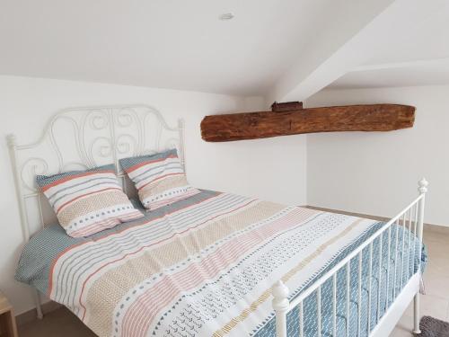 a bedroom with a bed with a log on the wall at Romantic Suite in Cabasse