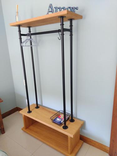 a wooden stand with a shelf on top at Casa da Lu Itacoatiara -Suite Alto Mourão in Niterói