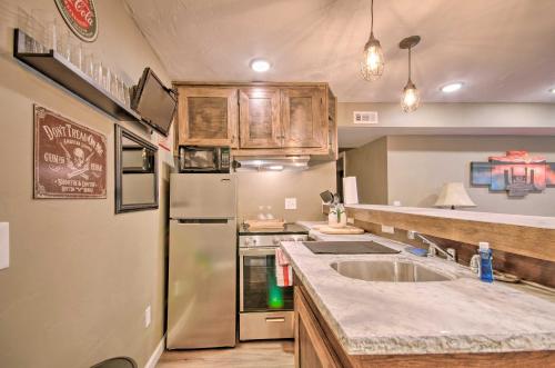 a kitchen with a refrigerator and a sink at Hilltop Osage Beach Home with Deck and Fire Pit! in Osage Beach
