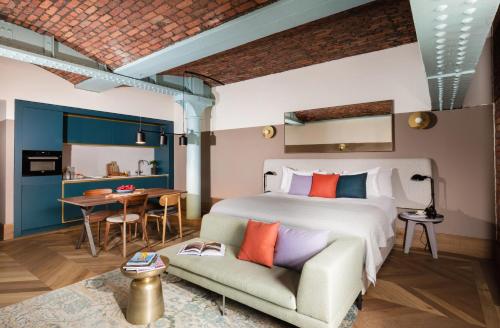 a bedroom with a bed and a couch and a table at Native Manchester in Manchester
