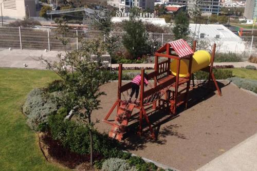a girl on a playground in a park at Nuevo y Lujoso departmento residencial Querétaro. in Querétaro