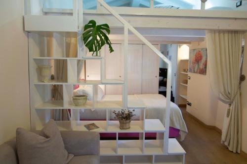 a room with a loft bed with a potted plant at Casa vacanze La Villetta tra Cinque Terre e Versilia in Ameglia