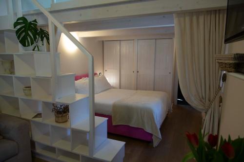 Ένα ή περισσότερα κρεβάτια σε δωμάτιο στο Casa vacanze La Villetta tra Cinque Terre e Versilia