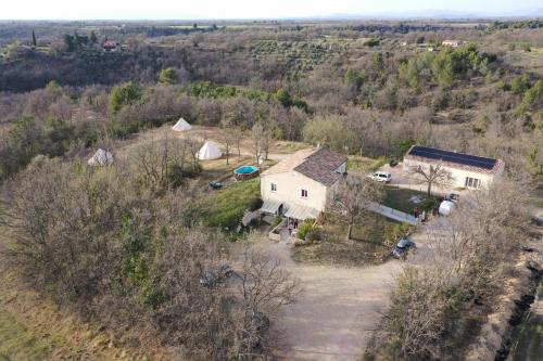 an aerial view of a house in a field at Camping Arbre de Vie in Montagnac