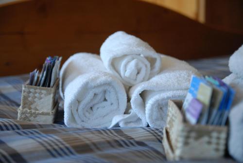 a pile of towels sitting on top of a bed at Bed & Breakfast Castello Regina in Brembilla
