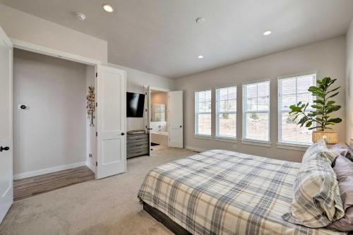 a bedroom with a bed and a flat screen tv at Inviting Hideout Townhome with Balcony and Lake Views! in Keetley