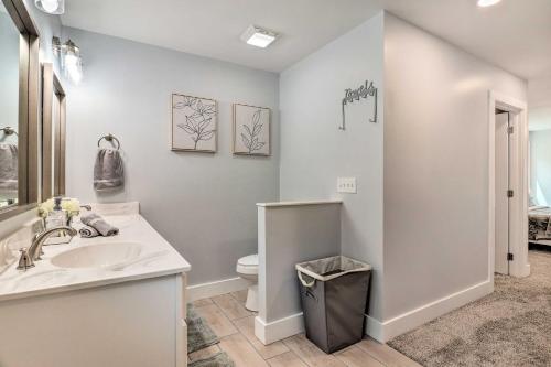 a bathroom with a sink and a toilet at Waynesville Smart Cabin with Hot Tub and Views! in Waynesville