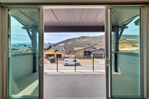 an open window with a view of a house at Inviting Hideout Townhome with Balcony and Lake Views! in Keetley