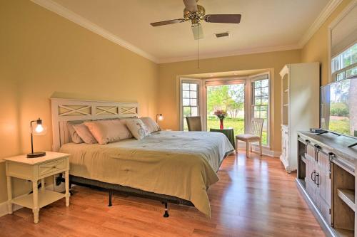 a bedroom with a bed and a ceiling fan at Cottage with Deck and Pool Access about 6 Mi to Beach in Myrtle Beach