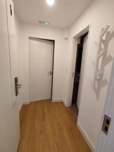 an empty room with a door and a wooden floor at Residencial Douro in Peso da Régua