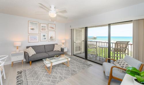 a living room with a couch and a view of the ocean at Chateau by the Sea in Cocoa Beach