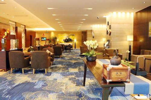 a hotel lobby with chairs and a waiting room at Holiday Inn Nanjing Aqua City by IHG in Nanjing